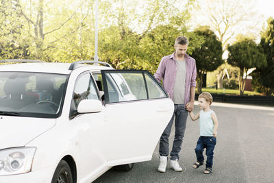 Rear view of two boys on car