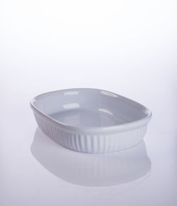 Close-up of empty casserole on table against white background