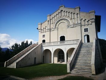 Low angle view of bell tower against blue sky