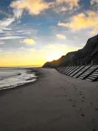 Scenic view of beach against sky during sunset