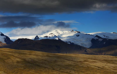 Scenic view of snowcapped mountains against sky