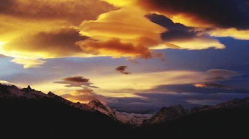 Scenic view of mountains against cloudy sky