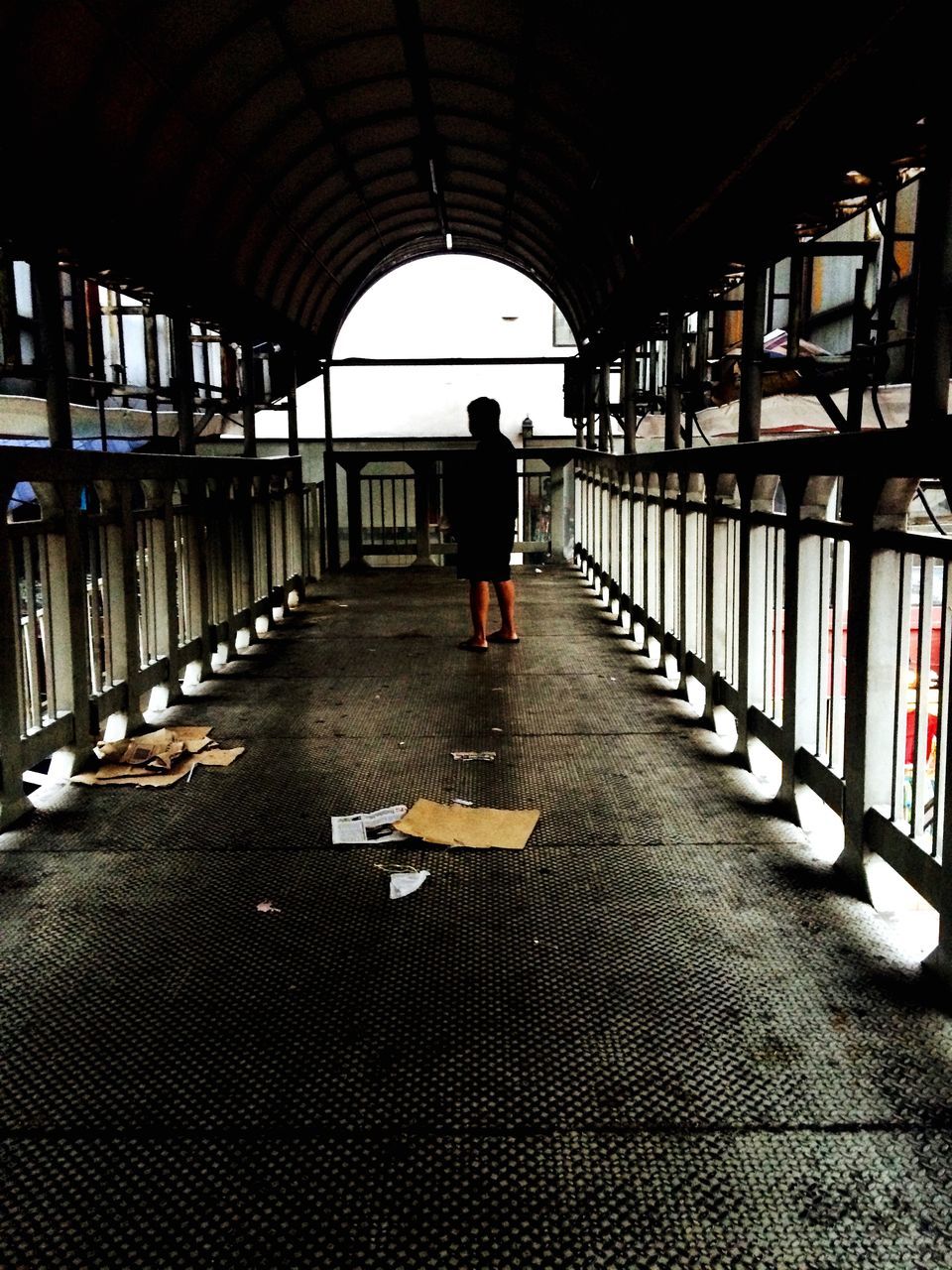 indoors, lifestyles, walking, full length, the way forward, rear view, men, transportation, leisure activity, person, diminishing perspective, standing, tunnel, architecture, silhouette, subway, built structure, ceiling