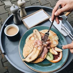 High angle view of man having breakfast on table