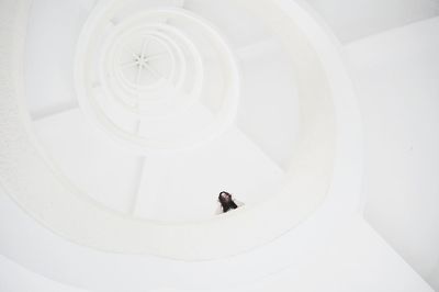 Low angle view of woman standing on steps in building