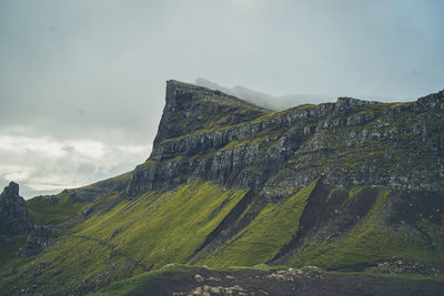 Scenic view of land and mountains against sky