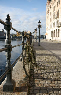 Bicycle in city against sky