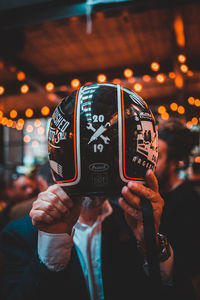 Close-up of person holding mobile phone at night