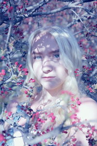 Portrait of woman against pink flowering plants