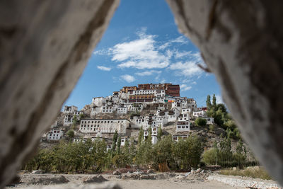 Old buildings seen through rocks against sky