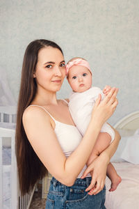 Portrait of a smiling young woman at home