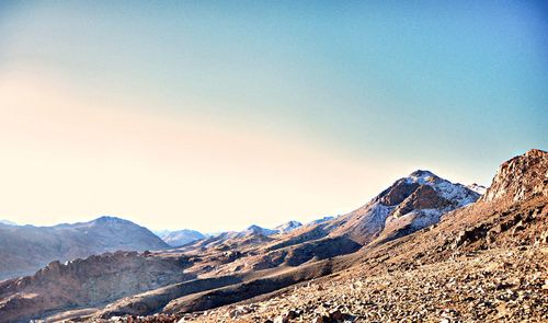 Scenic view of mountains against clear blue sky