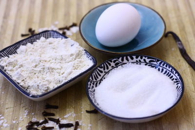 High angle view of coffee baking ingredients flour sugar clove and vanilla on table 