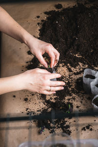 High angle view of woman hand on sand