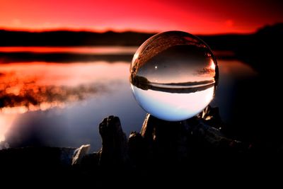 Close-up of a silhouette ball in calm water