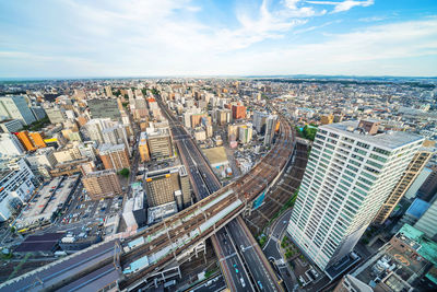 High angle view of modern buildings in city against sky