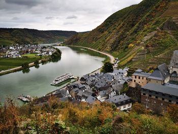 High angle view of townscape by lake against sky