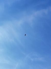 Low angle view of human on a rope against sky