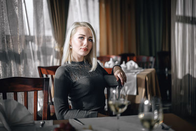 Young woman sitting on table