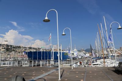 Sailboats in harbor against sky