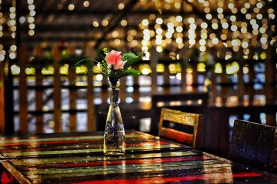 Close-up of illuminated flower vase on table