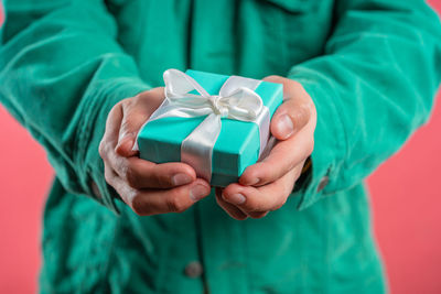 Midsection of man holding gift