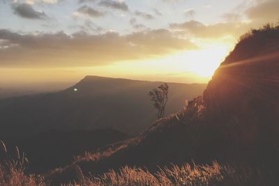 Scenic view of silhouette mountains against sky at sunset