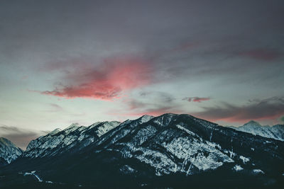 Scenic view of snowcapped mountains against sky during sunset