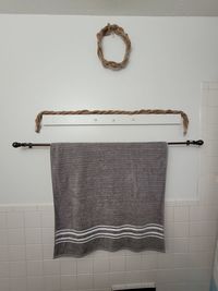 Close-up of clothes hanging on white wall at home