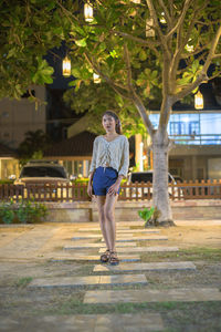 Full length portrait of man standing on footpath