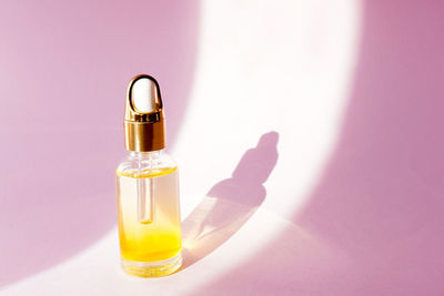 Close-up of perfume bottle on table