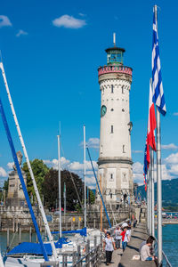 View of lighthouse by sea against sky