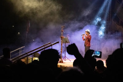 Side view of young man singing