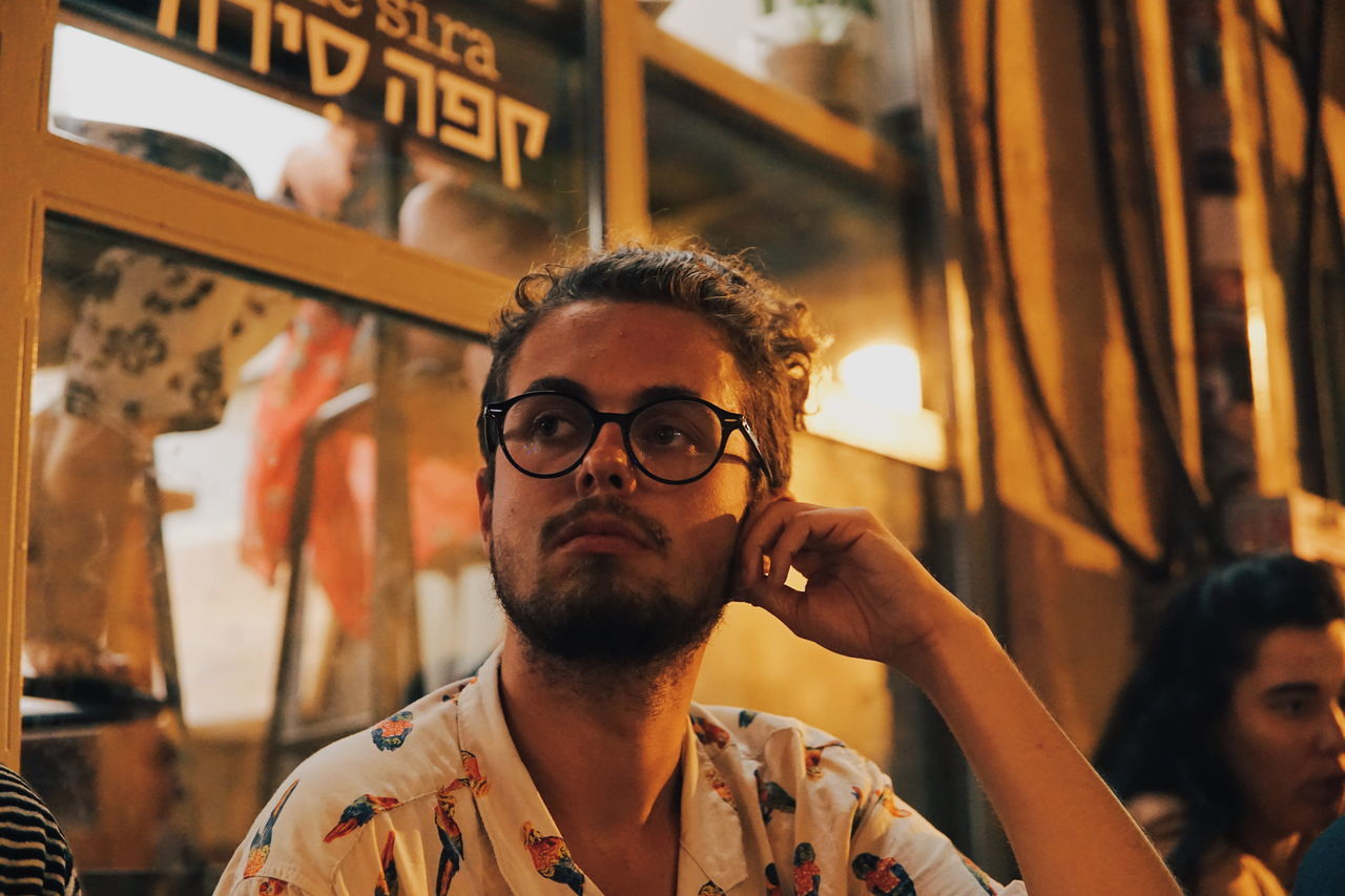 adult, glasses, eyeglasses, beard, facial hair, men, portrait, young adult, communication, headshot, vision care, hipster, person, business, one person, city, lifestyles, eyewear, front view, casual clothing, architecture, indoors, looking, focus on foreground, leisure activity