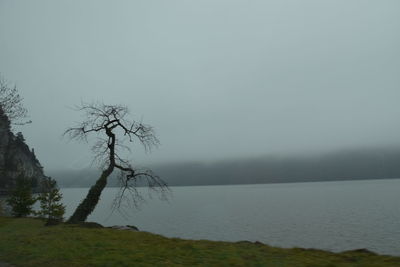 Scenic view of lake against sky during foggy weather