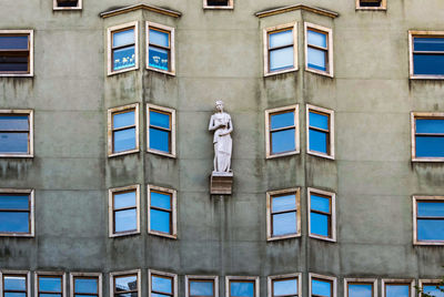 Low angle view of statue against building, barcelona. 