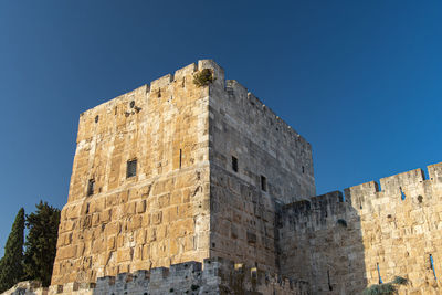 Low angle view of historic building against blue sky