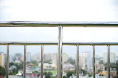 Close-up of cityscape against sky seen through window