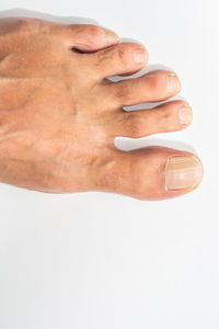 Close-up of human hand against white background