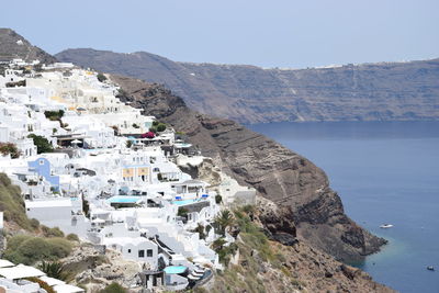 High angle view of buildings by sea against sky