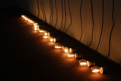 Close-up of illuminated lights against sky