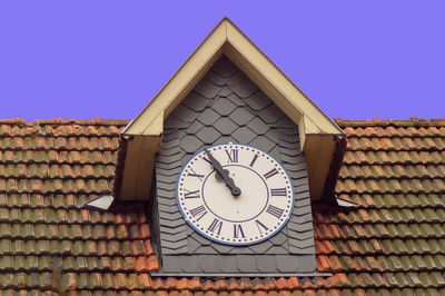 Low angle view of clock tower against building