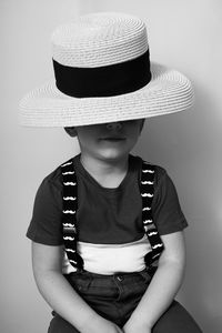 Girl wearing hat standing against white background