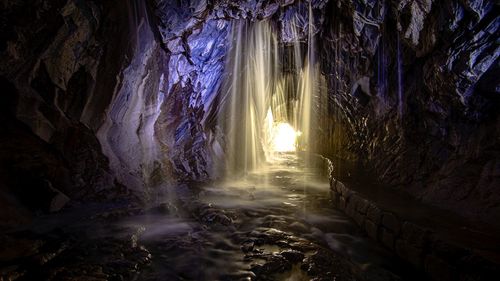 Sunlight streaming through rocks in cave