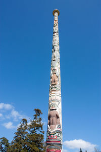 Low angle view of tower against blue sky