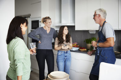 Family having conversation in kitchen