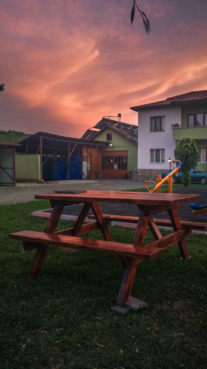 architecture, built structure, sky, building exterior, sunset, nature, building, seat, dusk, house, grass, cloud, no people, furniture, evening, plant, land, outdoors, front or back yard, table, bench, chair, residential district, wood, playground, tree, night