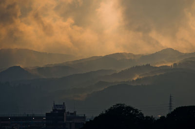 Scenic view of silhouette mountains against sky during sunset