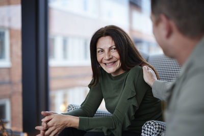 Man touching smiling woman's shoulder