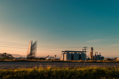 Billboard and silos in a field at sunrise